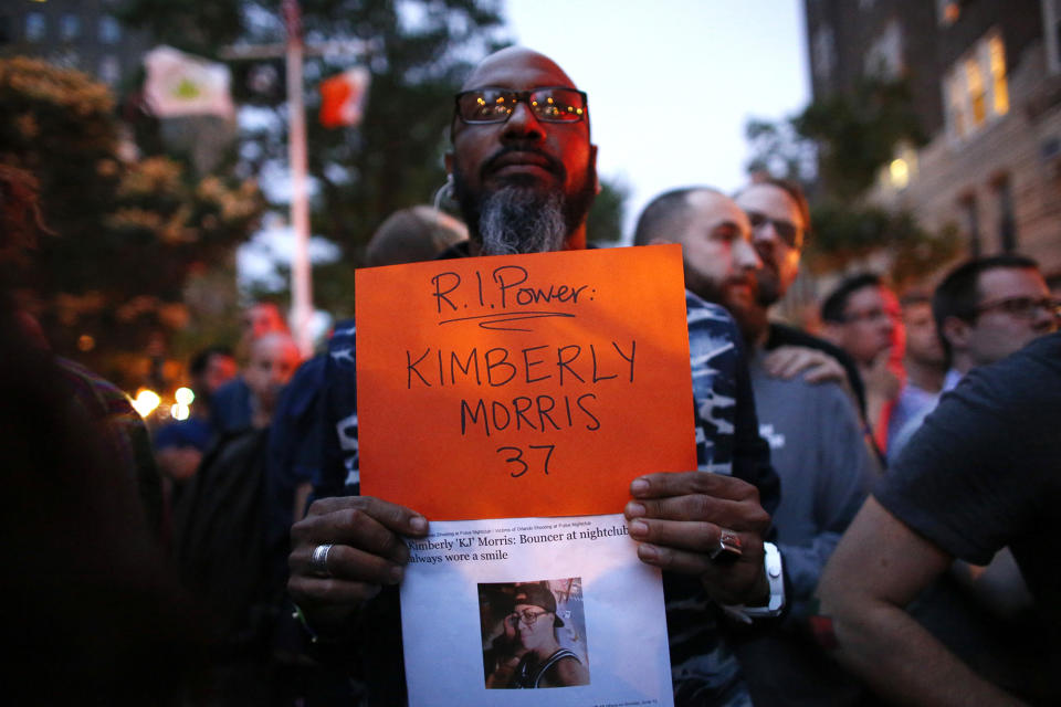 <p>A man holds a banner with the name of one of the victims during a vigil in solidarity in New York on June 13 ,2016, for the victims killed at Pulse nightclub in Orlando. (Photo: Kena Betancur/AFP/Getty Images) </p>