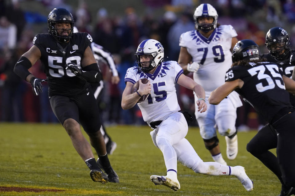 TCU quarterback Max Duggan (15) runs from Iowa State defensive end Eyioma Uwazurike (58) and linebacker Jake Hummel (35) during the first half an NCAA college football game, Friday, Nov. 26, 2021, in Ames, Iowa. (AP Photo/Charlie Neibergall)