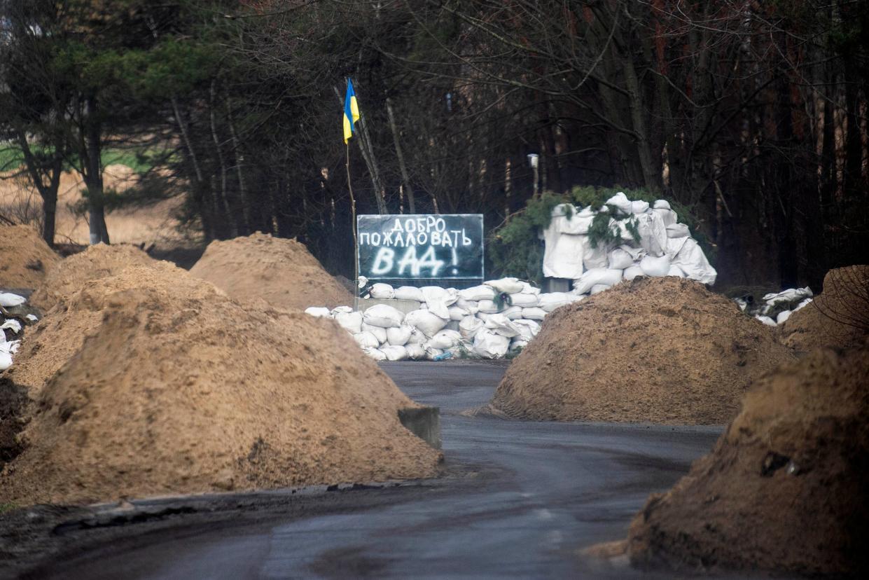 In Russian, a sign reads “Welcome to Hell” on a road entering Chernihiv, Ukraine after Russian forces retreated on April 7, 2022. This story was produced in partnership with the Pulitzer Center.