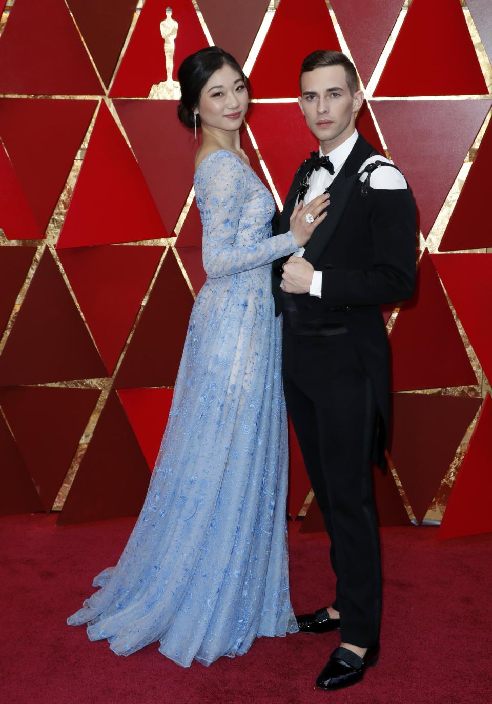 AXG001. Los Angeles (United States), 04/03/2018.- Mirai Nagasu (L) and Adam Rippon arrive for the 90th annual Academy Awards ceremony at the Dolby Theatre in Hollywood, California, USA, 04 March 2018. The Oscars are presented for outstanding individual or collective efforts in 24 categories in filmmaking. (Estados Unidos) EFE/EPA/PAUL BUCK