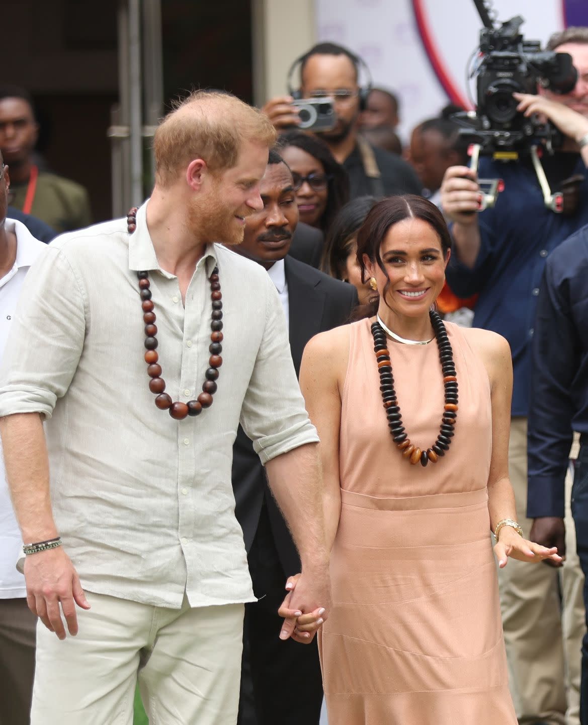abuja, nigeria may 10 duke of sussex prince harry l his wife meghan markle r, duchess of sussex, visit the lightway academy in abuja, nigeria as part of celebrations of invictus games anniversary on may 10, 2024 photo by emmanuel osodianadolu via getty images