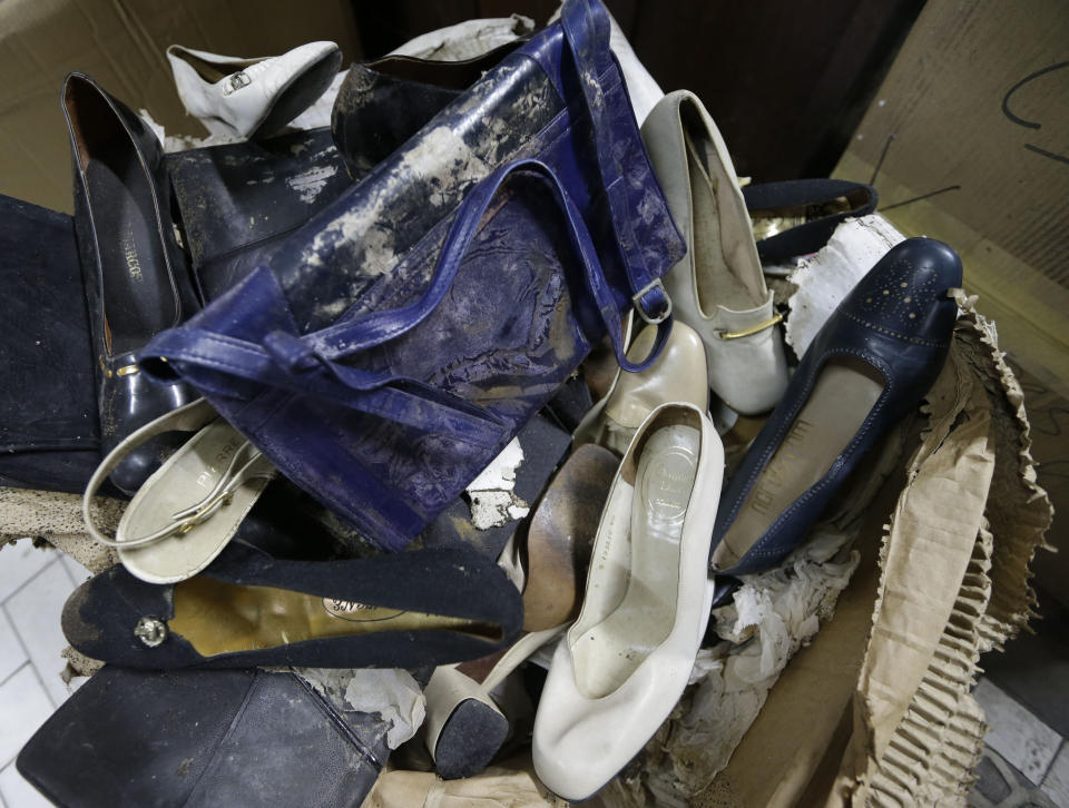 In this photo taken Sept. 19, 2012, branded high heel shoes, once worn by flamboyant former Philippine first lady Imelda Marcos sit among equally-damaged shoes and bags in a section of the National Museum in Manila, Philippine. Termites, storms and government neglect have damaged some of Imelda Marcos's legendary stash of shoes, expensive gowns and other vanity possessions, which were left to oblivion after she and her dictator husband were driven to U.S. exile by a 1986 popular revolt. (AP Photo/Bullit Marquez)