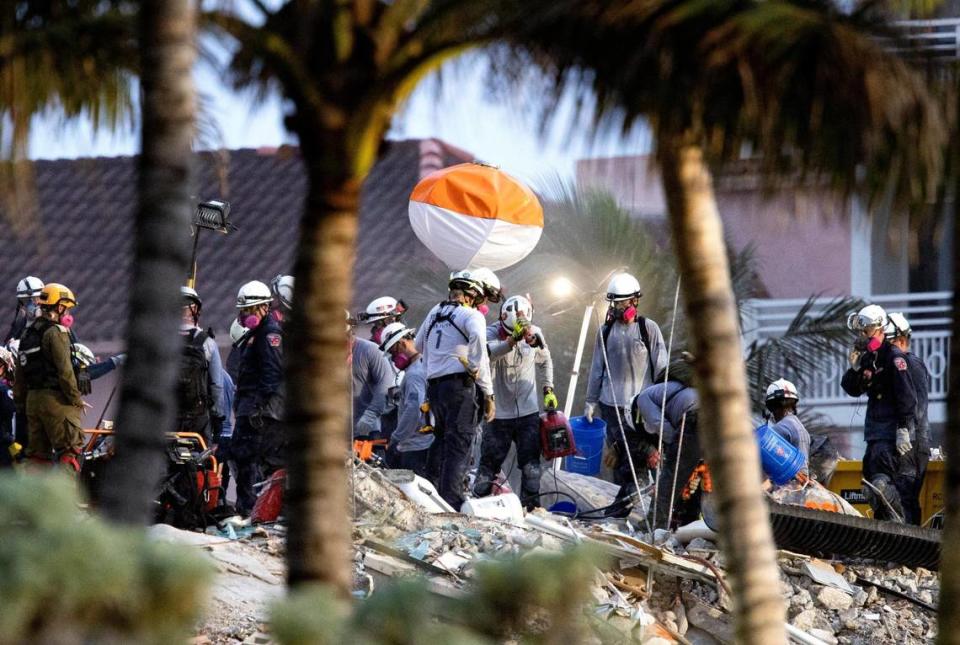 Search and rescue personnel search for survivors through the rubble at the Champlain Towers South Condo in Surfside, Florida, Wednesday, June 30, 2021. The apartment building partially collapsed on Thursday, June 24.