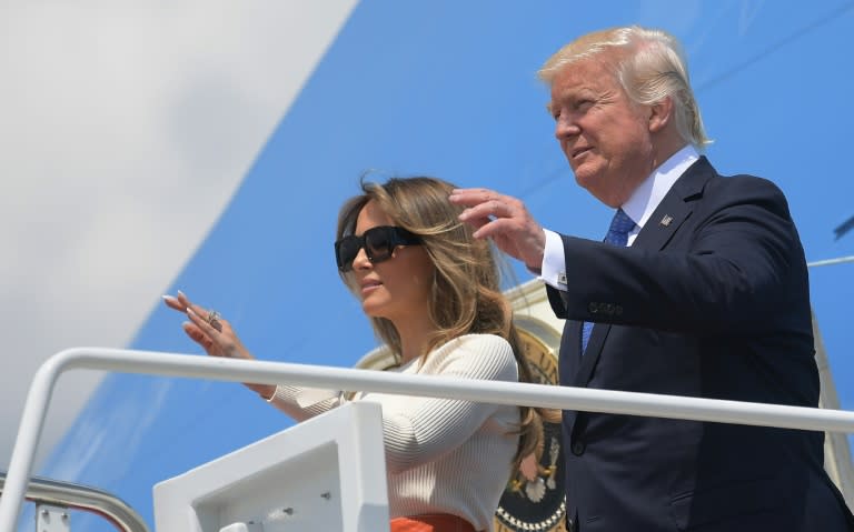 Donald Trump and his wife Melania wave before boarding Air Force One for his first trip abroad as US president