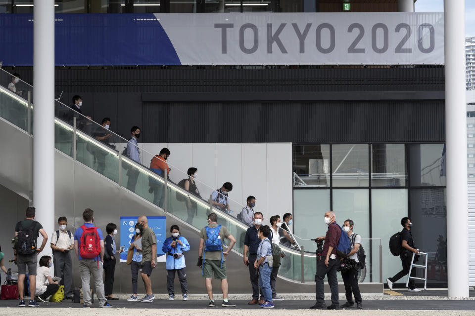 Journalists gather at Multifunctional Complex at the Tokyo 2020 Olympic and Paralympic Village during a media tour Sunday, June 20, 2021, in Tokyo. (AP Photo/Eugene Hoshiko)