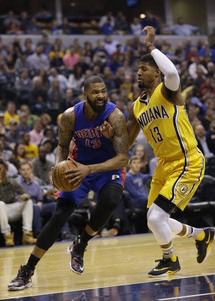 Detroit Pistons forward Marcus Morris, left, drives on Indiana Pacers forward Paul George during the first half of an NBA basketball game in Indianapolis, Saturday, Feb. 6, 2016. (AP Photo/Michael Conroy)