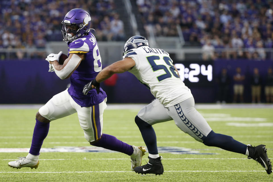 Minnesota Vikings tight end Irv Smith, left, runs from Seattle Seahawks outside linebacker Austin Calitro, right, after making a reception during the first half of an NFL preseason football game, Sunday, Aug. 18, 2019, in Minneapolis. (AP Photo/Bruce Kluckhohn)