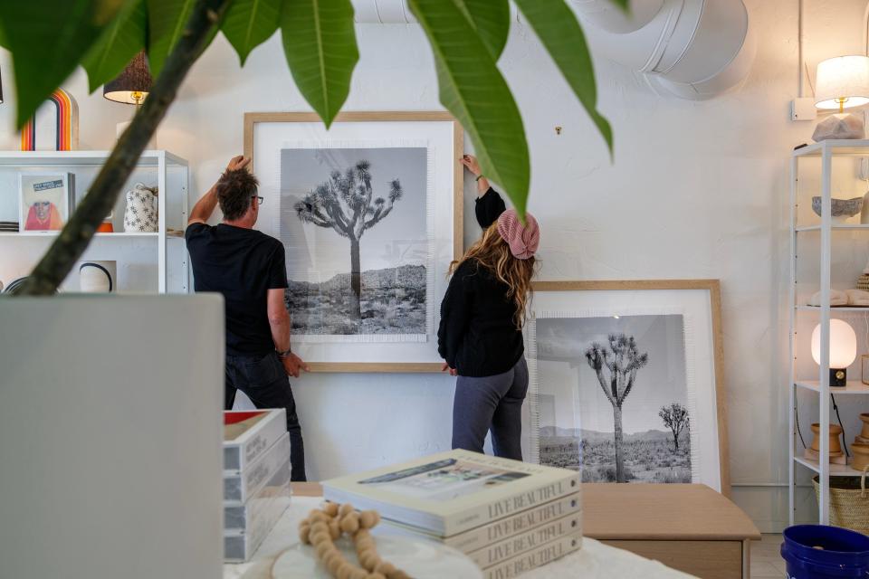 Argentine artist Marcelo Bengoechea, left, and his girlfriend, Kelli Silva, display his "Karma Tree #3" artwork series for sale and on exhibit inside Super Simple in Palm Springs, Calif., on Wednesday, Feb. 15, 2023.