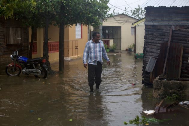 A man wades through a flooded street in Nagua, Dominican Republic, on September 19 (Photo: ERIKA SANTELICES via Getty Images)