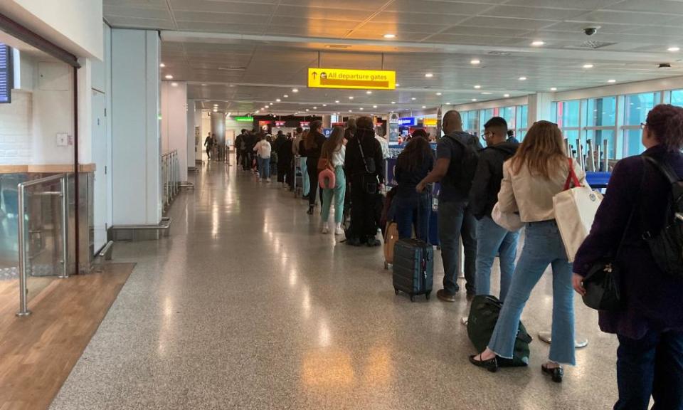 Passengers queue for flights at Heathrow airport.