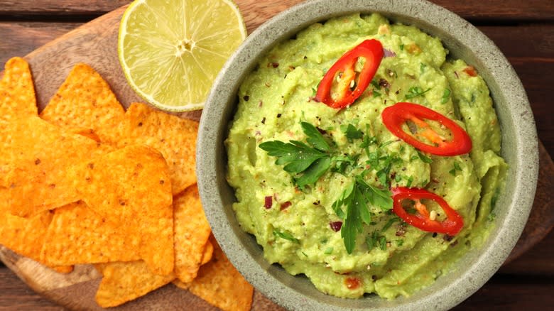 Guacamole with seasoning and garnishes