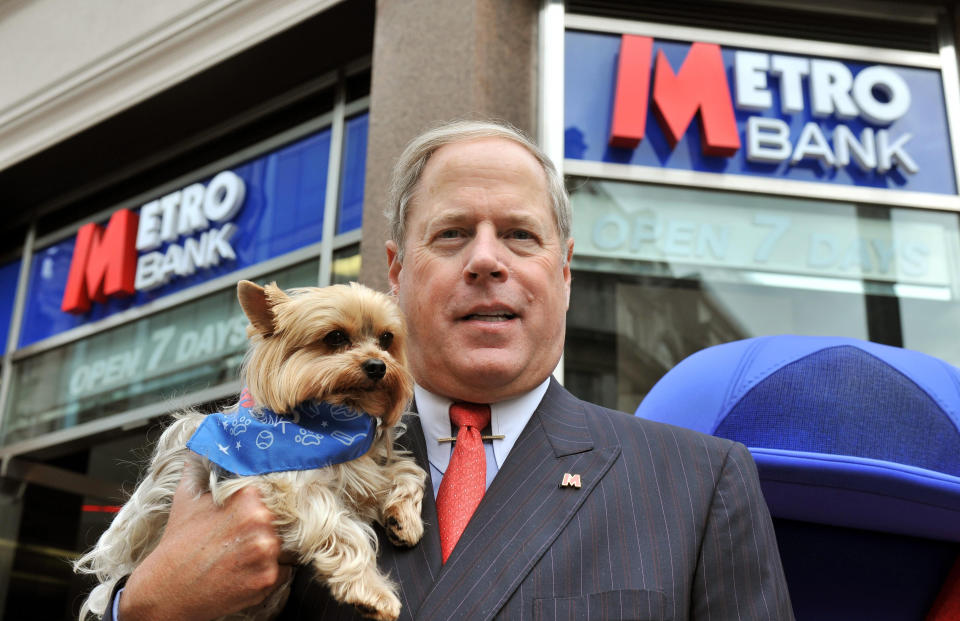 RETRANSMITTED WITH ADDITIONAL CAPTION INFORMATION. ADDING DOG'S NAME Founder and Vice Chairman  Vernon Hill II with his dog Duffy, outside the newly opened Metro Bank branch in Holborn, central London. The first high street bank to launch in the UK for more than 100 years opened its doors to customers today but its products received a lukewarm response from industry commentators.   (Photo by John Stillwell/PA Images via Getty Images)