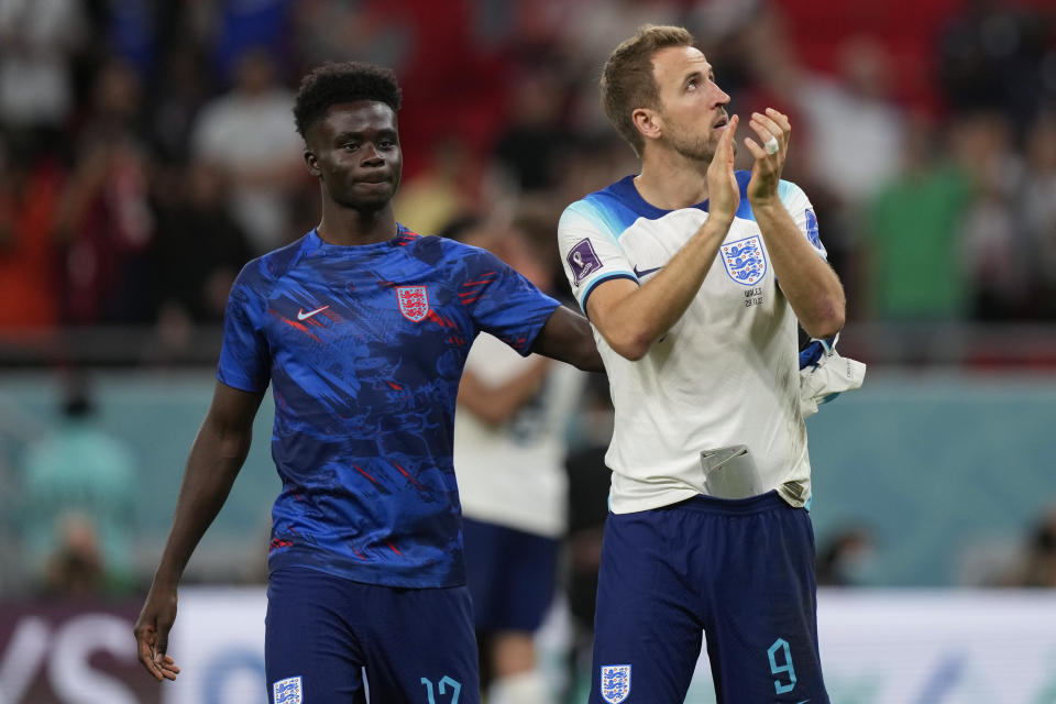 England's Harry Kane, right, applauds to supporters at the end of the World Cup group B soccer match between England and Wales, at the Ahmad Bin Ali Stadium in Al Rayyan , Qatar, Tuesday, Nov. 29, 2022. England won 3-0. (AP Photo/Frank Augstein)