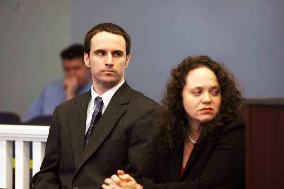 U.S. Army Pvt. Christopher Salmon, left, accompanied by his attorney, Gabrielle Amber Pittman, listens during a hearing Thursday, April 3, 2014, in a Long County, Ga. courtroom. Salmon pleaded guilty to malice murder charges in the killing of former military colleague Michael Roark, and was sentenced to life in prison with no chance of parole. (AP Photo/Lewis Levine)