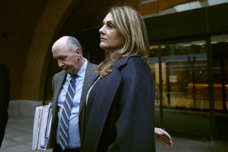 Michelle Janavs stands with attorney Thomas Bienert outside federal court, Tuesday, Feb. 25, 2020, in Boston, after she was sentenced to five months in prison for trying to cheat and bribe her daughters' way into college as part of a nationwide college cheating scam. (AP Photo/Elise Amendola)