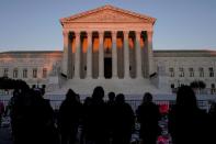 FILE PHOTO: People gather to mourn the death of Associate Justice Ruth Bader Ginsburg at the Supreme Court in Washington