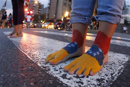 Anti-government protesters march barefooted during a protest in Caracas April 16, 2014. REUTERS/Christian Veron