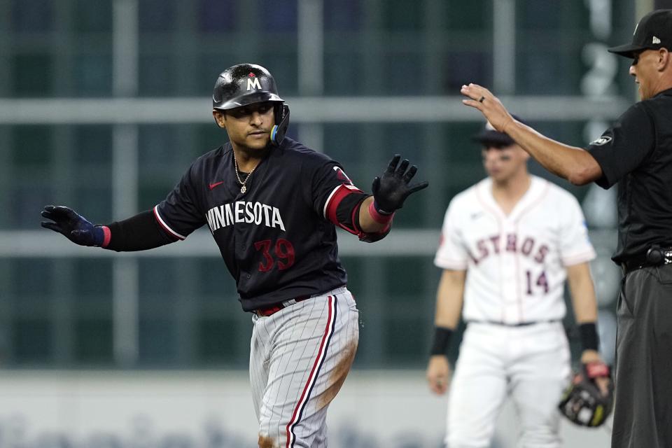 Minnesota Twins' Donovan Solano (39) calls for time after hitting a two-run double against the Houston Astros during the sixth inning of a baseball game Wednesday, May 31, 2023, in Houston. (AP Photo/David J. Phillip)