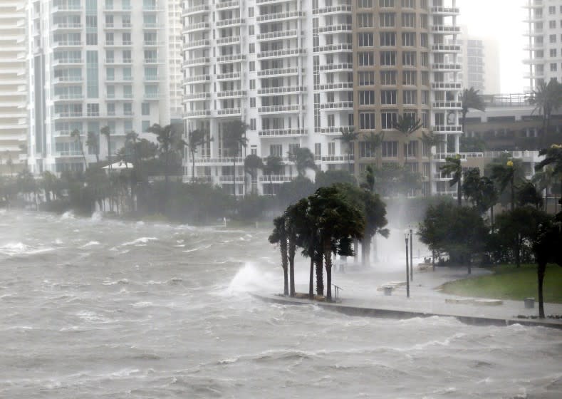 FILE - In this Sept. 10, 2017 file photo waves crash over a seawall at the mouth of the Miami River from Biscayne Bay, during Hurricane Irma, in Miami. The year's biggest news stories chronicled an historic hurricane season that had Florida in its crosshairs. Hurricane Irma knocked out power for millions across wide swaths of the state on both coasts, from Key West to Jacksonville, left homes destroyed and lives disrupted. (AP Photo/Wilfredo Lee, File)