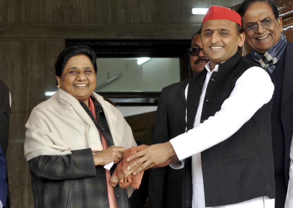 FILE - In this Jan. 15, 2019, file photo, Samajwadi Party President Akhilesh Yadav, right, greets Bahujan Samaj Party chief Mayawati on her birthday in Lucknow, India. Longtime political archrivals in India's most populous state have stitched an inventive political alliance that fuses votes from the ancient Hindu caste system to take on the ruling Hindu nationalist party-led government. (AP Photo/Nirala Tripathi)