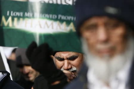 Muslim demonstrators hold placards during a protest against the publication of cartoons depicting the Prophet Mohammad in French satirical weekly Charlie Hebdo, near Downing Street in central London February 8, 2015. REUTERS/Stefan Wermuth