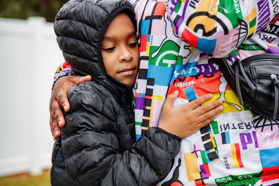 Terrance Johnson, 8, hugs his mother, Lechaye Johnson as she fights back tears sharing the stress and anxiety she is suffering from with the severe rent increase at the mobile home park she lives in Tuesday, Jan. 25, 2022. What was formerly known as the Meadows Mobile Home Park is now under new management known as Florida Sun Estates. 