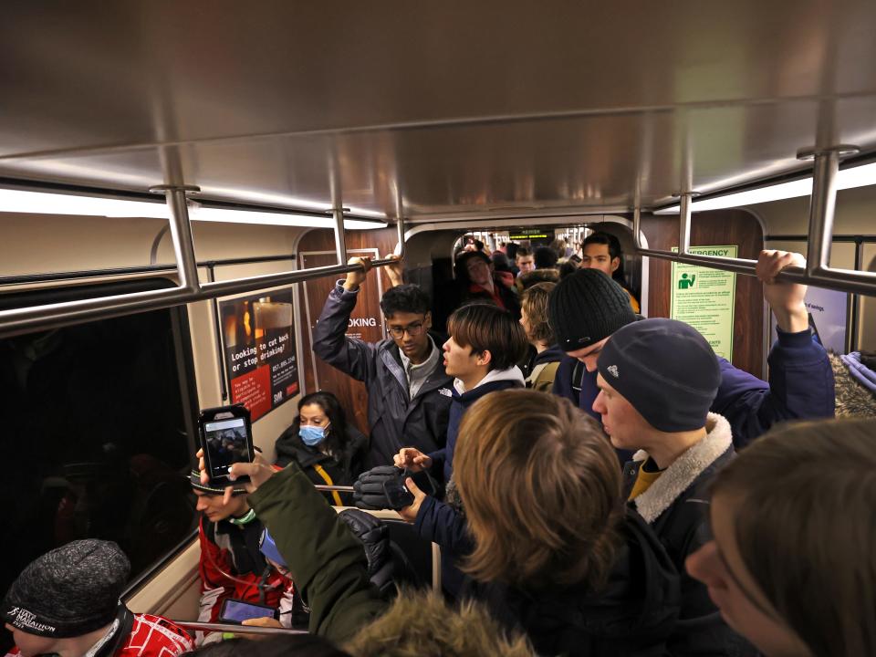 Riders pack in for the first ride of the new Green Line Extension, which left from the Medford/Tufts station at 4:30 am.