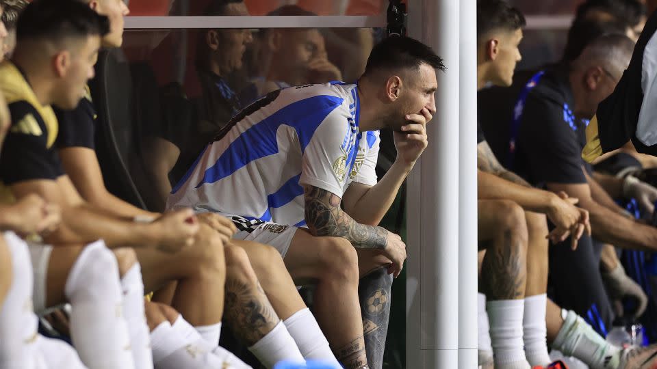 A visibly emotional Lionel Messi watches the game from the bench after he came off injured. - Buda Mendes/Getty Images