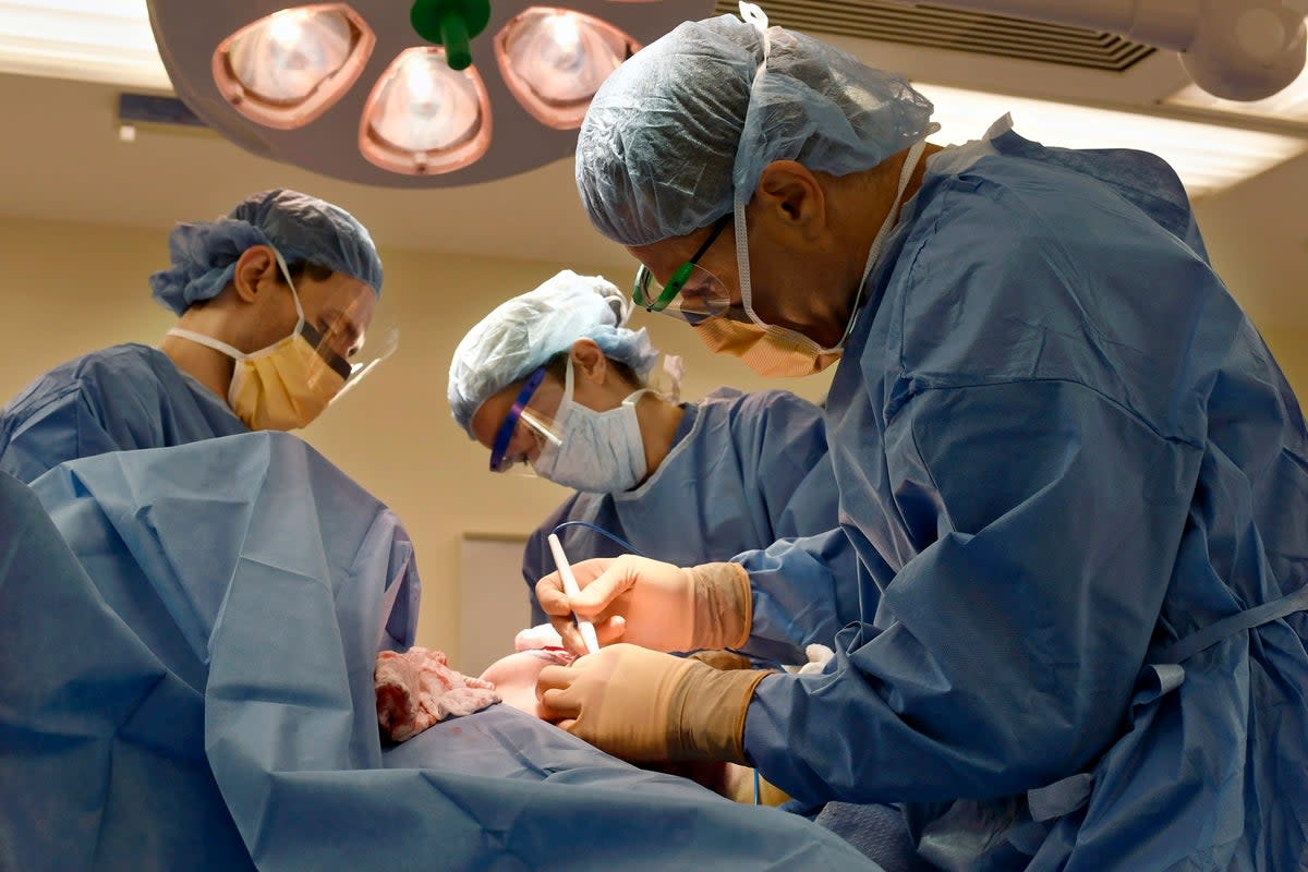 Surgeons perform a bilateral mastectomy on a transgender patient at a hospital in Boston on Friday, July 15, 2016.  (AP)