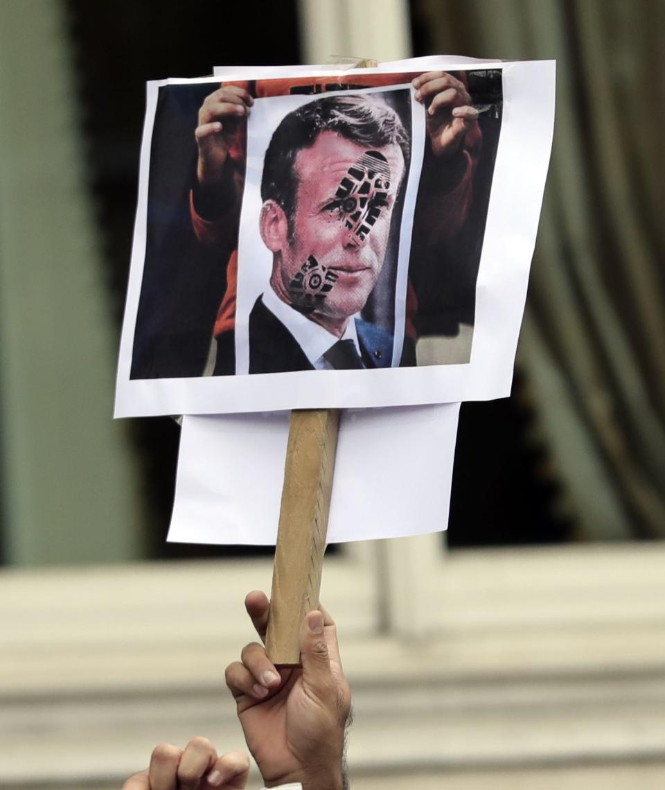 <p>Protesters carried signs of French president Emmanuel Macron</p>PA