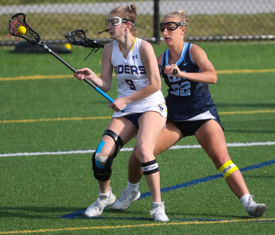 Caesar Rodney's Elise Hensley (left) works against Cape Henlopen's Megan Smith in the second half of Cape Henlopen's 17-6 win at Caesar Rodney, Wednesday, April 26, 2023.