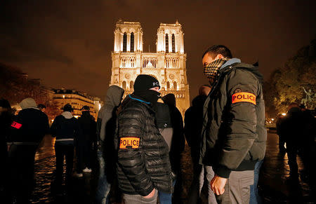 Police officers gather during an unauthorised protest against anti-police violence in front of the Notre Dame Cathedral in Paris, France, October 21, 2016. REUTERS/Jacky Naegelen