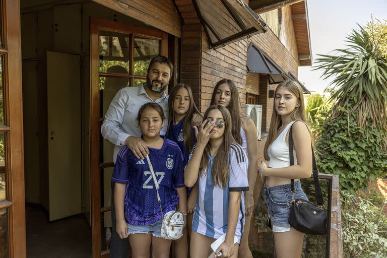 Ariel Fernando García, the new owner of Diego Maradona’s former home, with his daughters on what was once Maradona’s balcony, in Buenos Aires, Argentina, Dec. 13, 2022. The house is one of several Maradona owned in Buenos Aires. (Sarah Pabst/The New York Times)