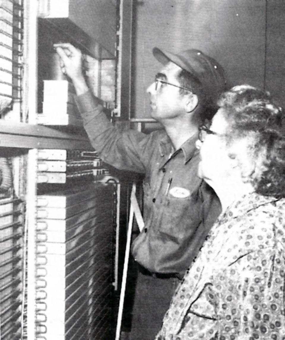 Norm Smith explains the new dial equipment to his mother, Katie Smith, before the changeover in November 1956.
