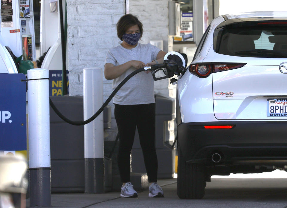 SAN FRANCISCO, CALIFORNIA - OCTOBER 12: A customer pumps gas into her car at a Shell station on October 12, 2021 in San Francisco, California. The San Francisco Bay Area has the highest gas prices in the United States with an average price of $4.55 per gallon of regular unleaded. The national average is $3.31 per gallon, up 6 cents over the last two weeks and over $1.00 since last year. (Photo by Justin Sullivan/Getty Images)