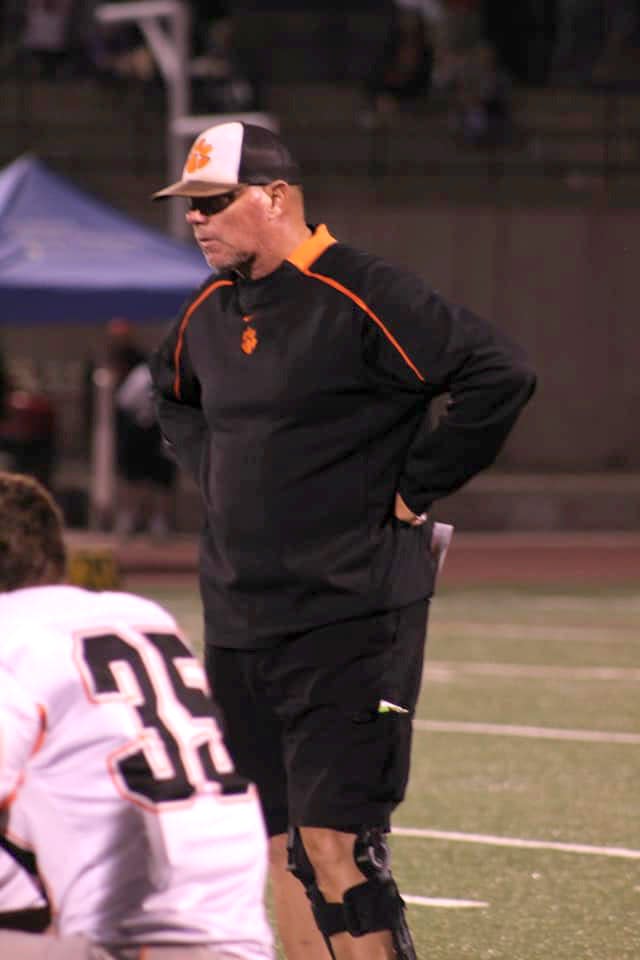 Aztec head football coach Eric Stovall watches pregame warmups before a game at Shiprock High School, Friday, Oct. 1.