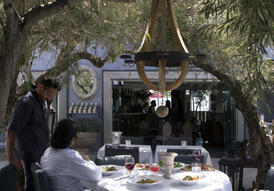 Workers prepare for the opening of Pump restaurant in West Hollywood.