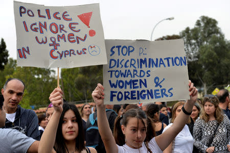 FILE PHOTO: Protesters hold up placards during a public vigil in memory of the victims of a suspected serial killer outside the Presidential Palace in Nicosia, Cyprus, April 26, 2019. REUTERS/Stefanos Kouratzis/File Photo