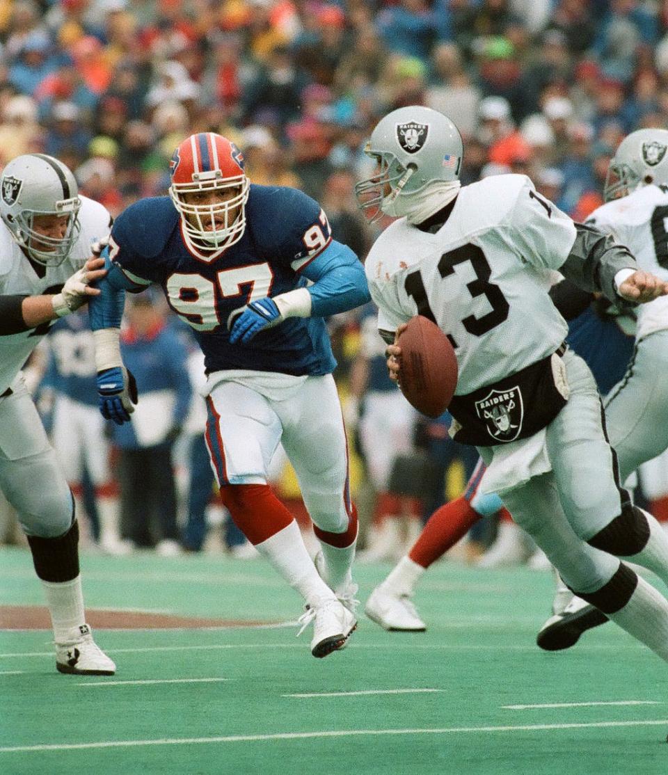 Bills linebacker Cornelius Bennett  chases down Raiders quarterback Jay Schroeder during the AFC Championship game on January 20, 1991. 