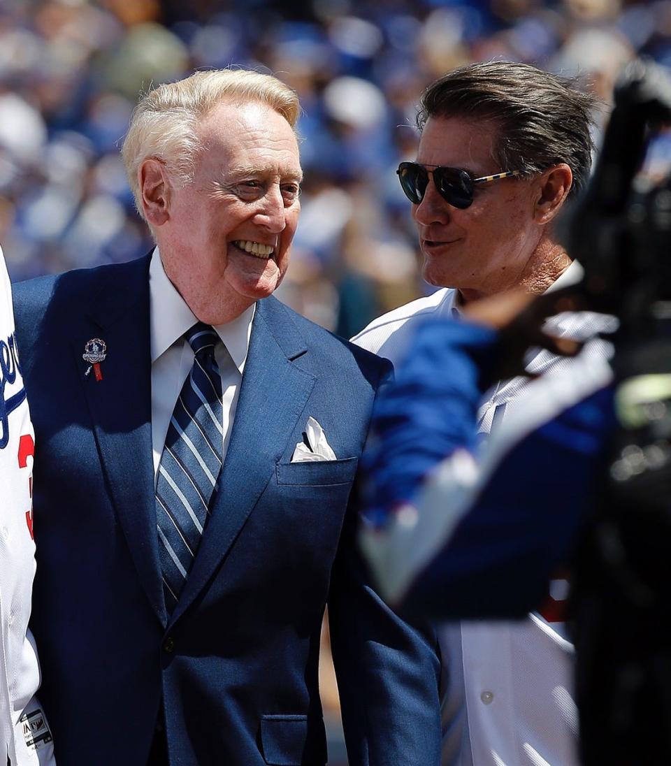 Los Angeles Dodgers broadcaster Vin Scully listens to former Dodger Steve Garvey on opening day at Dodger Stadium in 2016.