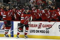 New Jersey Devils center Jack Hughes (86) celebrates with teammates after scoring a goal against the Chicago Blackhawks during the second period of an NHL hockey game Friday, Oct. 15, 2021, in Newark, N.J. (AP Photo/Adam Hunger)