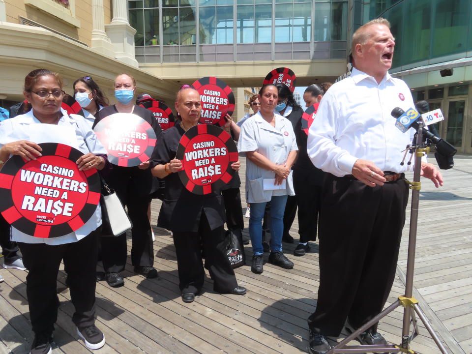 Bob McDevitt, left, president of Local 54 of the Unite here union, speaks at a press conference on the Atlantic City, N.J., Boardwalk on Wednesday, June 8, 2022, at which he announced the union filed a complaint with New Jersey officials accusing four casinos of failing to clean each occupied hotel room each day as required by an executive order from the governor. (AP Photo/Wayne Parry)