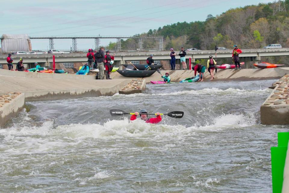 Kayakers paddle on the “paperclip” bypass on the Catawba River in Great Falls on March 19.