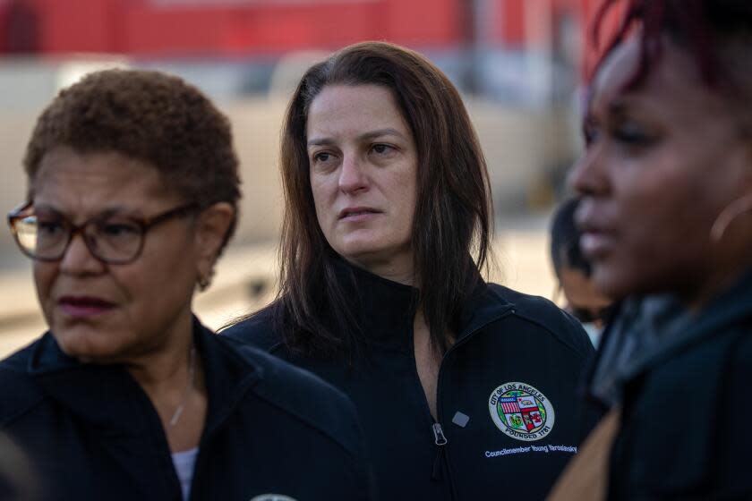 Los Angeles, CA - February 16: Mayor Karen Bass, left, Councilmember Katy Young Yaroslavsky, Director of Homelessness Strategies, and Annetta Wells, the mayor's director of community engagement , visit a homeless encampment behind the Academy Museum of Motion Pictures, to observe "Inside Safe" in action moving houseless to a motel on Thursday, Feb. 16, 2023 in Los Angeles, CA. (Irfan Khan / Los Angeles Times)