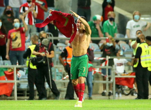 Cristiano Ronaldo holds up his shirt to the fans after scoring