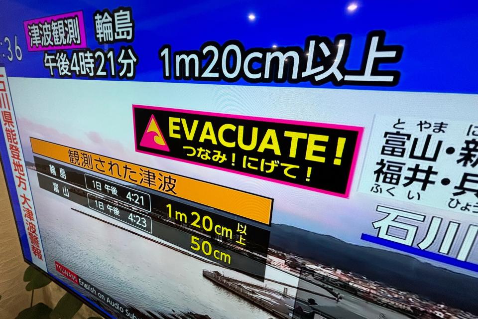 A tsunami warning is shown on TV in Yokohama, near Tokyo Monday, January 1, 2024