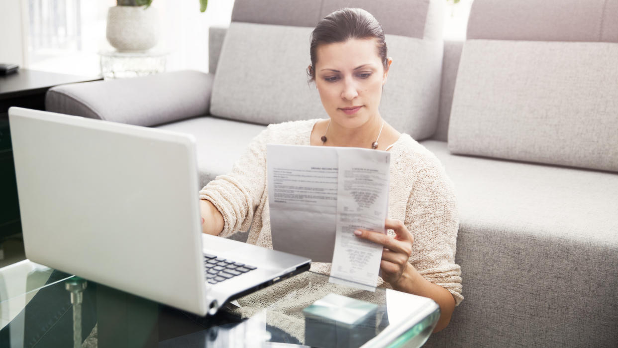 Woman in her 30s filling out tax information online.