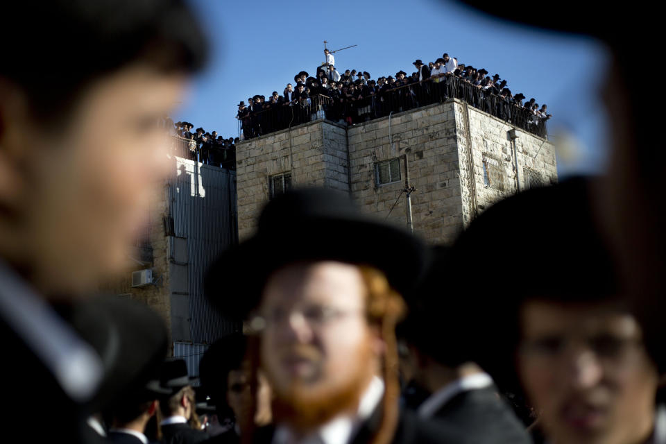 File - In this Oct. 7, 2013 file photo, Orthodox Jews gather to watch the funeral procession of Rabbi Ovadia Yosef in Jerusalem. Rabbi Yosef, was the religious scholar and spiritual leader of Israel's Sephardic Jews. The Spanish conservative government, which enjoys an absolute majority in Parliament, plans to make amends in weeks to come with a law that offers citizenship to the legions of Jews forced to flee Spain in 1492. (AP Photo/Ariel Schalit, File)