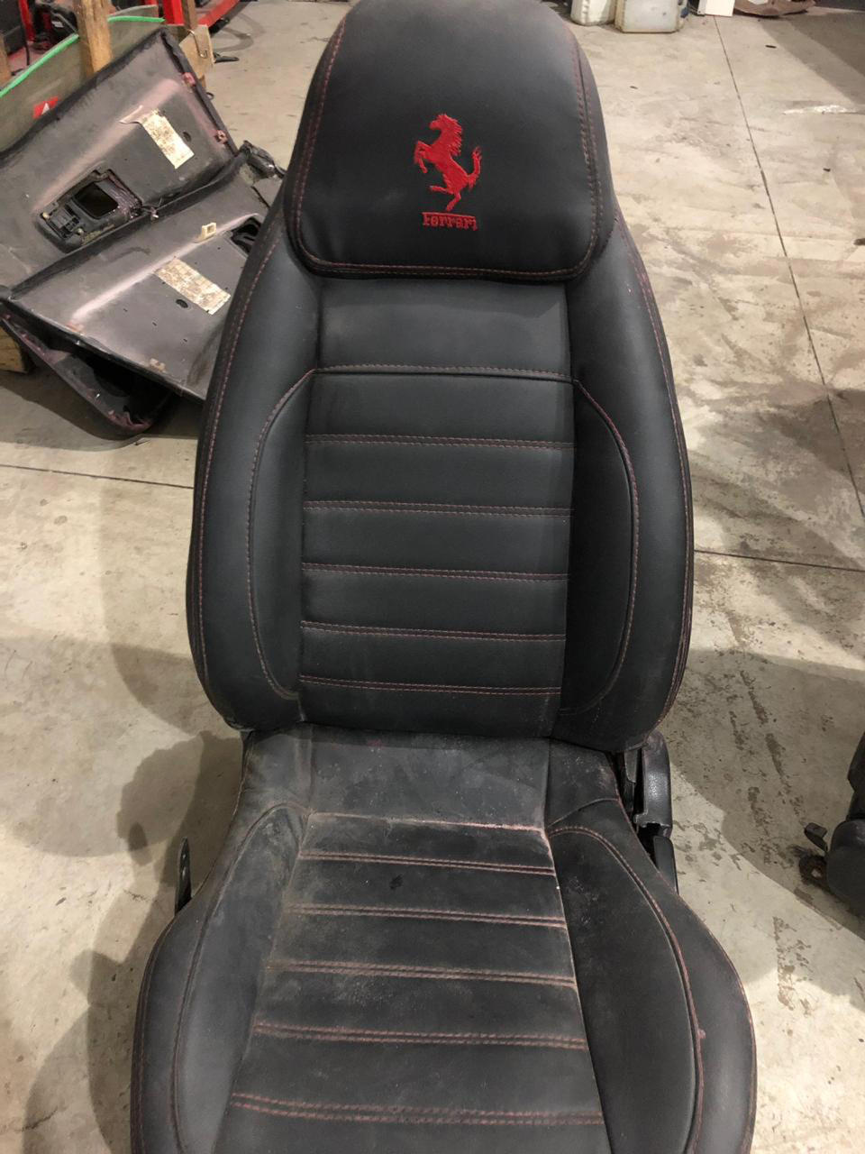 This July 15, 2019 photo released by Itajai Civil Police shows the seat of a car embroidered with a fake Ferrari logo, inside a workshop in Itajai, Brazil. Brazilian police dismantled the clandestine workshop run by a father and son who assembled fake Ferraris and Lamborghinis to order, in Brazil's southern state of Santa Catarina. (Itajai Civil Police via AP)