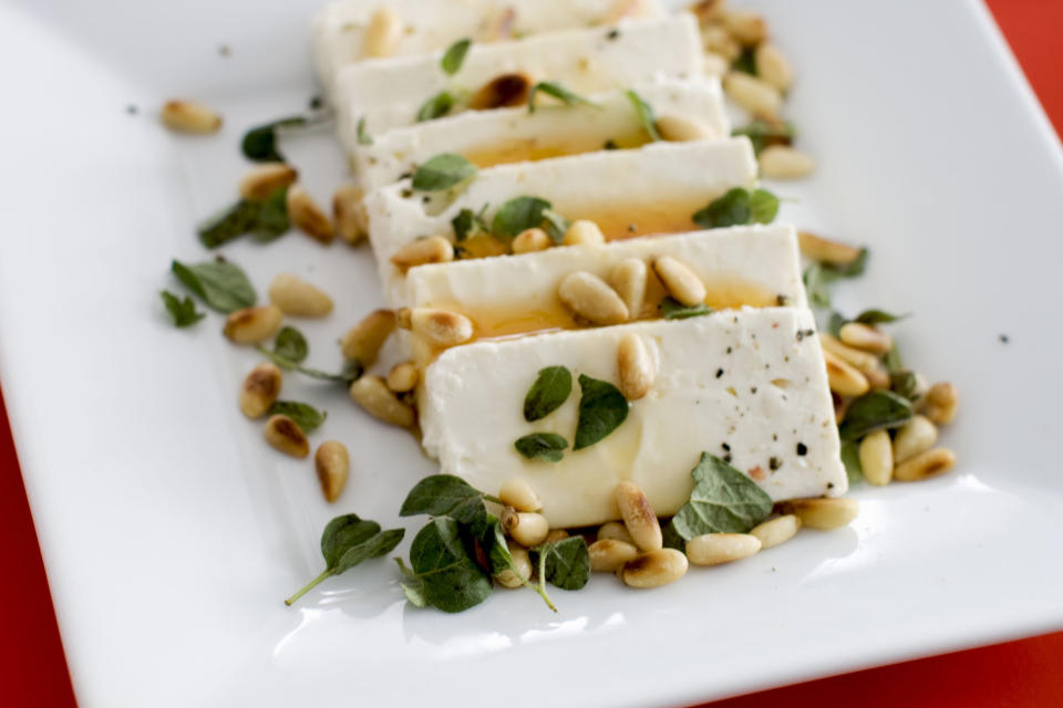 In this undated image, feta cheese and honey are shown served on a platter in Concord, N.H. (AP Photo/Matthew Mead)